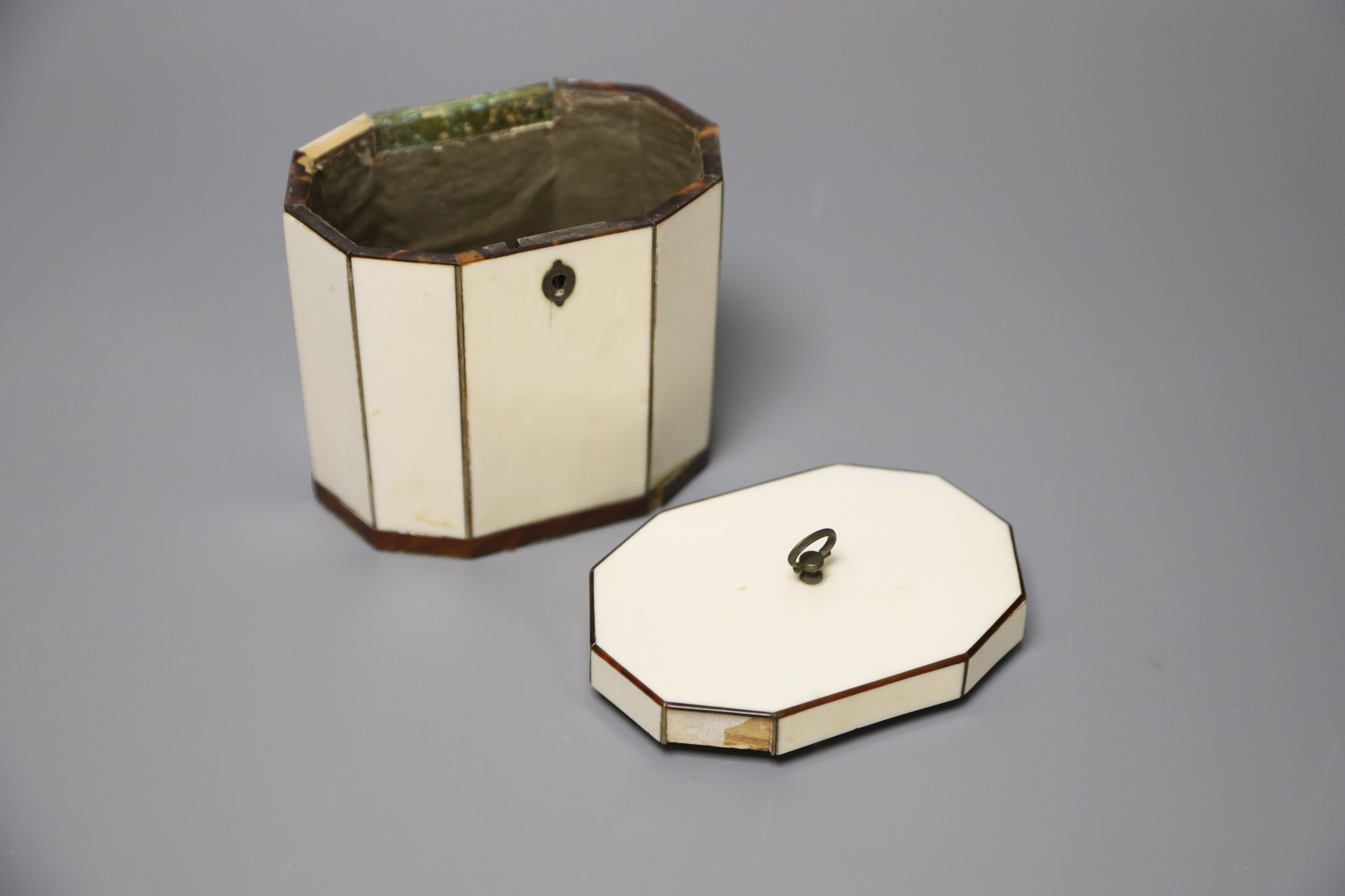 A George III octagonal ivory and tortoiseshell veneered tea caddy, height 10cm